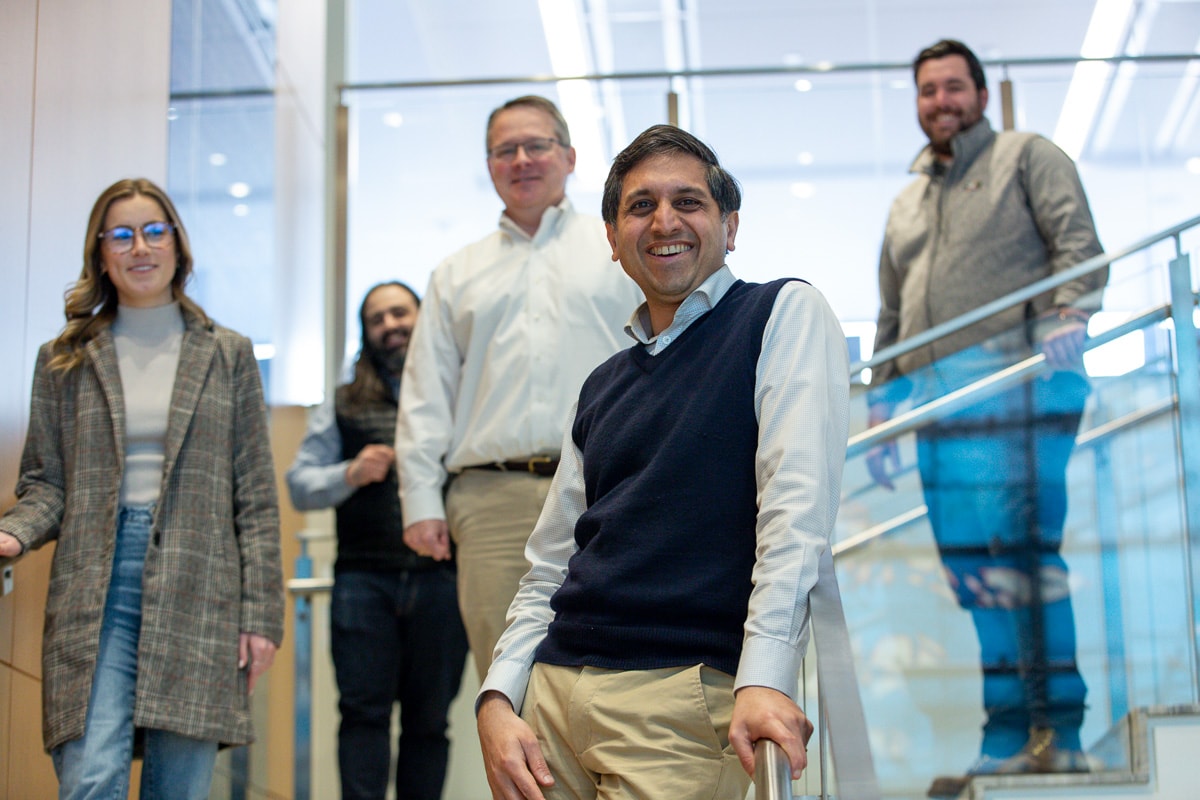 Five Abry team members standing together on the stairs